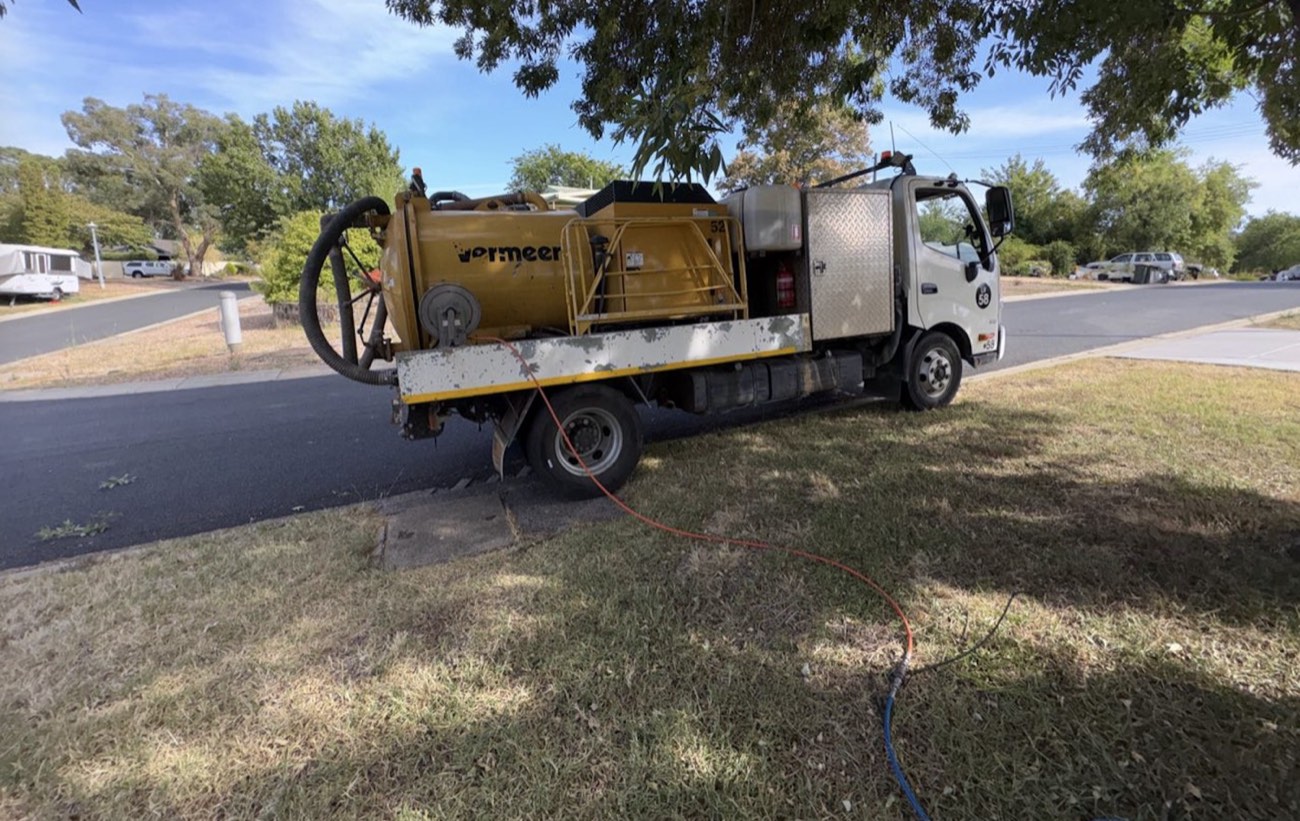 Compact vacuum truck clearing a pit in a Canberra street